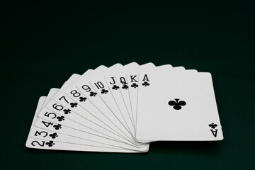 Full Deck of Clubs Playing Cards in Sequence on Green Table