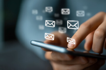 Person using smartphone with floating email icons display