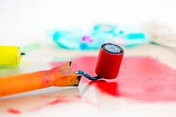 desktop graphics with a roller with red paint and a palette knife