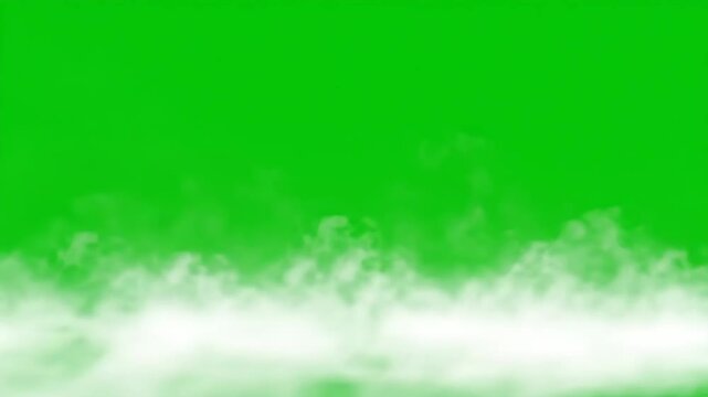 White smoke effect rolling on the ground over a green screen. Fog, gas, or steam on chromakey background for visual fx footage.