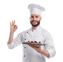 Happy confectioner in uniform holding delicious eclairs and showing ok gesture on white background