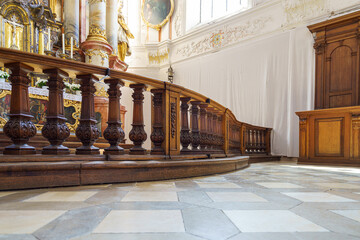 Wooden railing and ornate altar captured in a historic church interior during a quiet afternoon