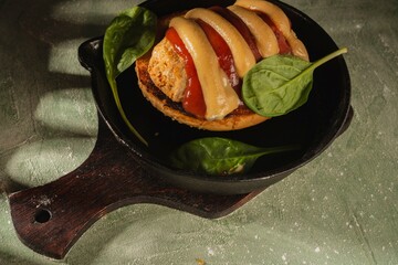Still life: sandwich, vegetables on a dark green background. Homemade food