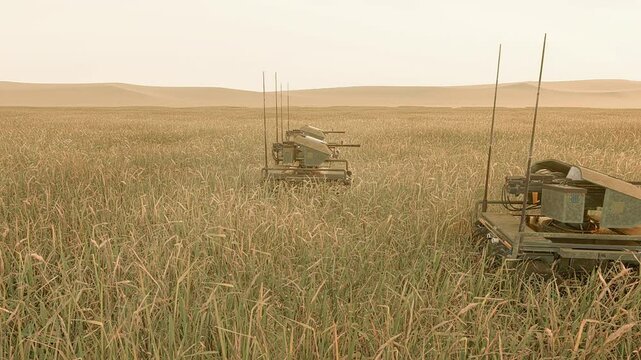 Multiple autonomous unmanned ground vehicles (UGVs), armed with remote weapon stations and sensors, are deployed in the tall grass of the battlefield to engage enemy targets.