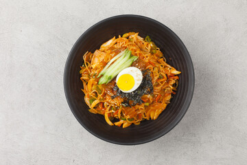 Bibim guksu is a type of noodle dish that is eaten without soup, mixed with meat, vegetables, and various seasonings.