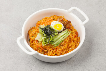 Bibim guksu is a type of noodle dish that is eaten without soup, mixed with meat, vegetables, and various seasonings.