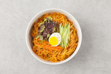 Bibim guksu is a type of noodle dish that is eaten without soup, mixed with meat, vegetables, and various seasonings.