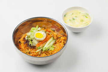 Bibim guksu is a type of noodle dish that is eaten without soup, mixed with meat, vegetables, and various seasonings.