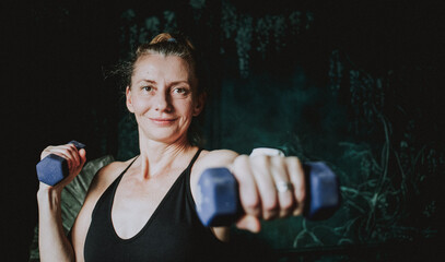 fit woman in her forties lifting weights