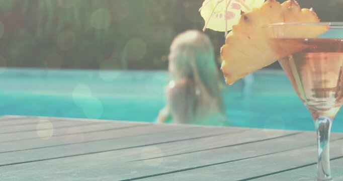 Woman exiting pool upon reaching deck for health break, with animated flares highlighting cocktail