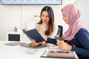 Teamwork process. Successful colleagues work and discuss their goals and plans together in an...