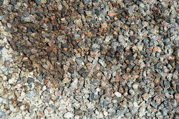 Different sizes and colors of gravel stones blend together, showcasing their texture and diversity in a construction environment