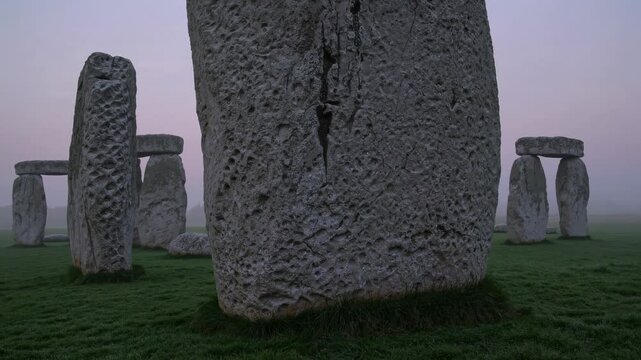 Mysterious stonehenge stands tall in the early morning mist, its ancient stones shrouded in an ethereal glow, creating a captivating scene of timeless wonder