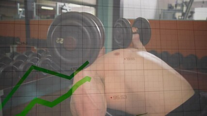 Male lifter gripping dumbbells and bench pressing while tracking progress with live graphs in gym