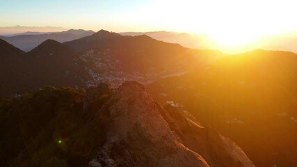 Aerial drone shot capturing the tranquil beauty of a Nainital morning, with sunlight painting the hills in warm tones. - Powered by Adobe
