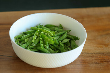 plate of peas on a wooden table. High quality photo