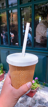 hand holding a cup of coffee