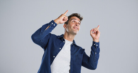 Advertising, man and pointing to presentation in studio for announcement, coming soon or about us. Mockup, ambassador and marketing space for information, promotion offer and news on white background