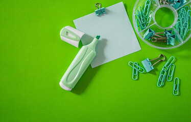 Back to School Flat Lay with cool Supplies on Bright green Background