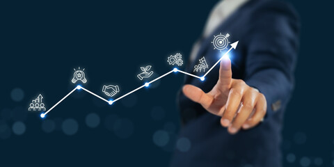 Business growth and success strategy concept. A business professional points at a glowing upward graph line with icons representing innovation, partnership, sustainability, teamwork, and achievement.