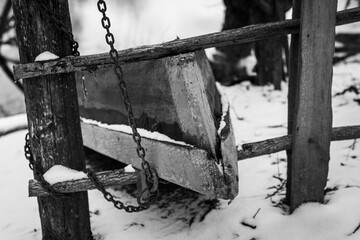Wooden Boat on the River Bank in the Village in Winter
