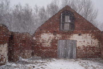 Snow Falling on Ancient Brick Ruins in a Winter Park