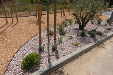 Decorative gravel landscaping with wood chips and flowerbed edging