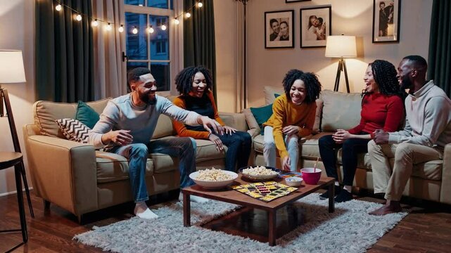 Friends playing board games and having fun at home
