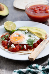 Huevos Rancheros on wooden table. Traditional Mexican breakfast