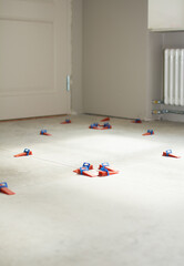Close-up of ceramic tile installation with tile clips and spacers for grouting