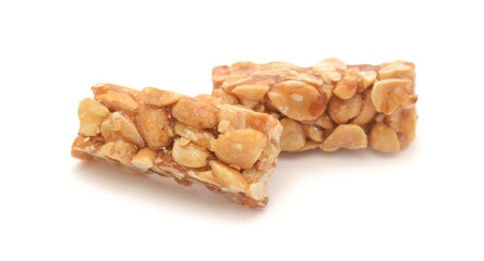 Pieces of nut brittle on white background