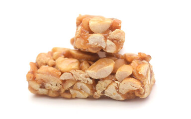 Pieces of nut brittle on white background