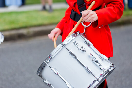 Young female drummer playing in local band during ANZAC day parade march