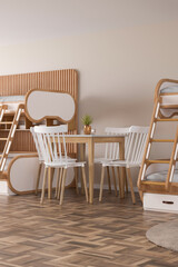Stylish hostel interior showcases a welcoming atmosphere with modern wooden bunk beds and a simple dining table set. Natural light enhances the inviting space, ideal for socializing