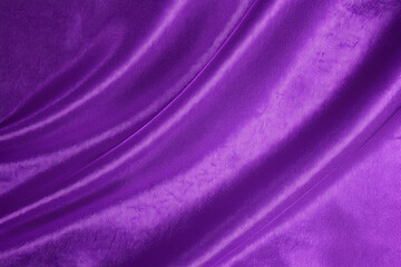 Close-up of a luxurious purple fabric with soft folds.
