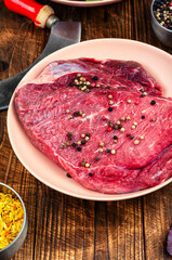 Raw cuts of meat, beef on rustic wooden table.