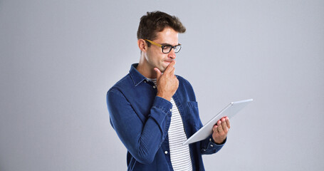 Programmer, tablet or man with thinking in studio for software glitch, planning or troubleshooting....