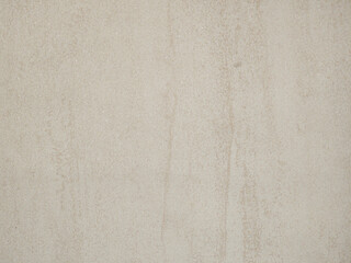 Textured concrete wall showcasing subtle variations in color and tone in a modern interior setting during daylight hours