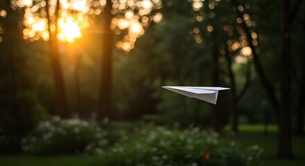 Paper Plane Drifting Through Park During Golden Hour, Surrounded by Nature and Soft Sunlight