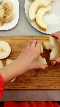Chef cutting korean melon on wooden board