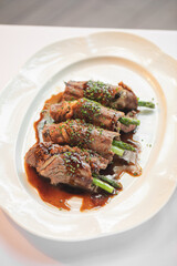 Portion of gourmet beef and asparagus rolls appetizer