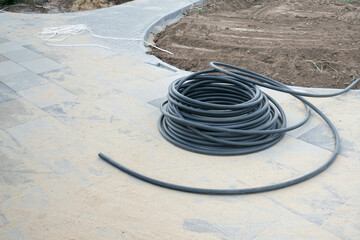 Construction materials are prepared for landscaping and paving work in a residential area during...