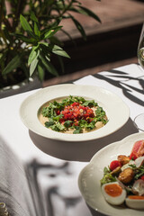 Portion of hummus appetizer with chopped pepper and onion