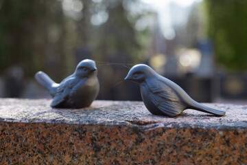 A peaceful Lutheric cemetery in Finland, featuring a solitary grave marked by a stone monument. The surroundings are calm and reflect a quiet, respectful atmosphere