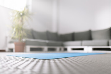 Calm indoor yoga space with a blue mat ready for practice on a serene afternoon