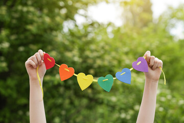 Teenager Holds Rainbow Hearts in his Hands. Heart Rainbow. LGBT. Pride Month. Lesbian Gay Bisexual Transgender. Love, human rights, tolerance