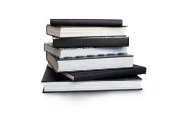 A front side eye level view of a pile of seven study books, textbooks, on a table isolated against a transparent background.