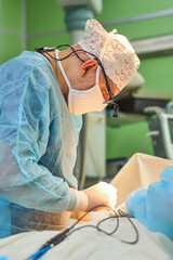 The surgeon is working hard in the operating room