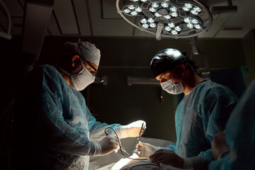 The surgeon is working hard in the operating room