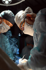 The surgeon is working hard in the operating room